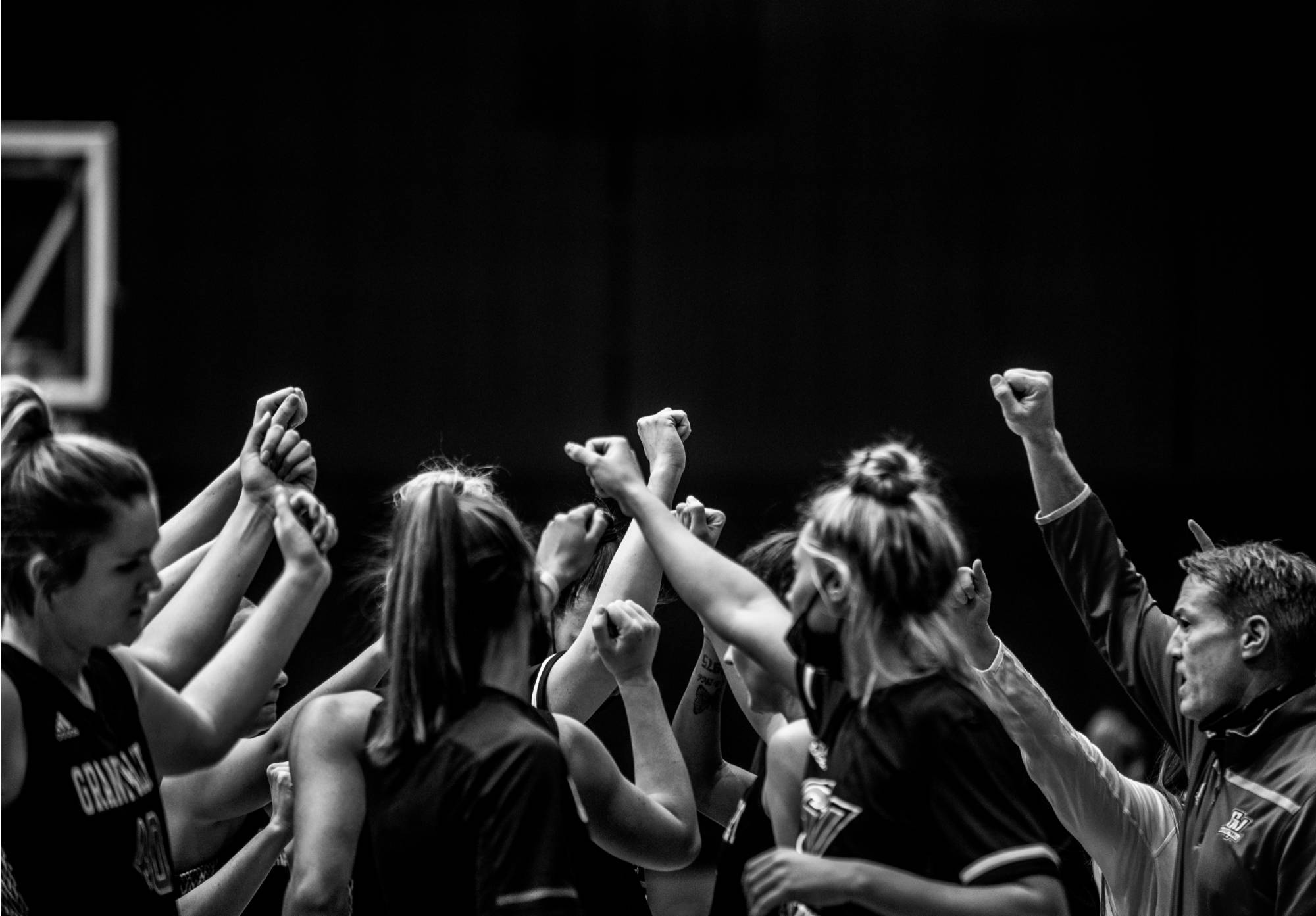 female basketball players in a huddle